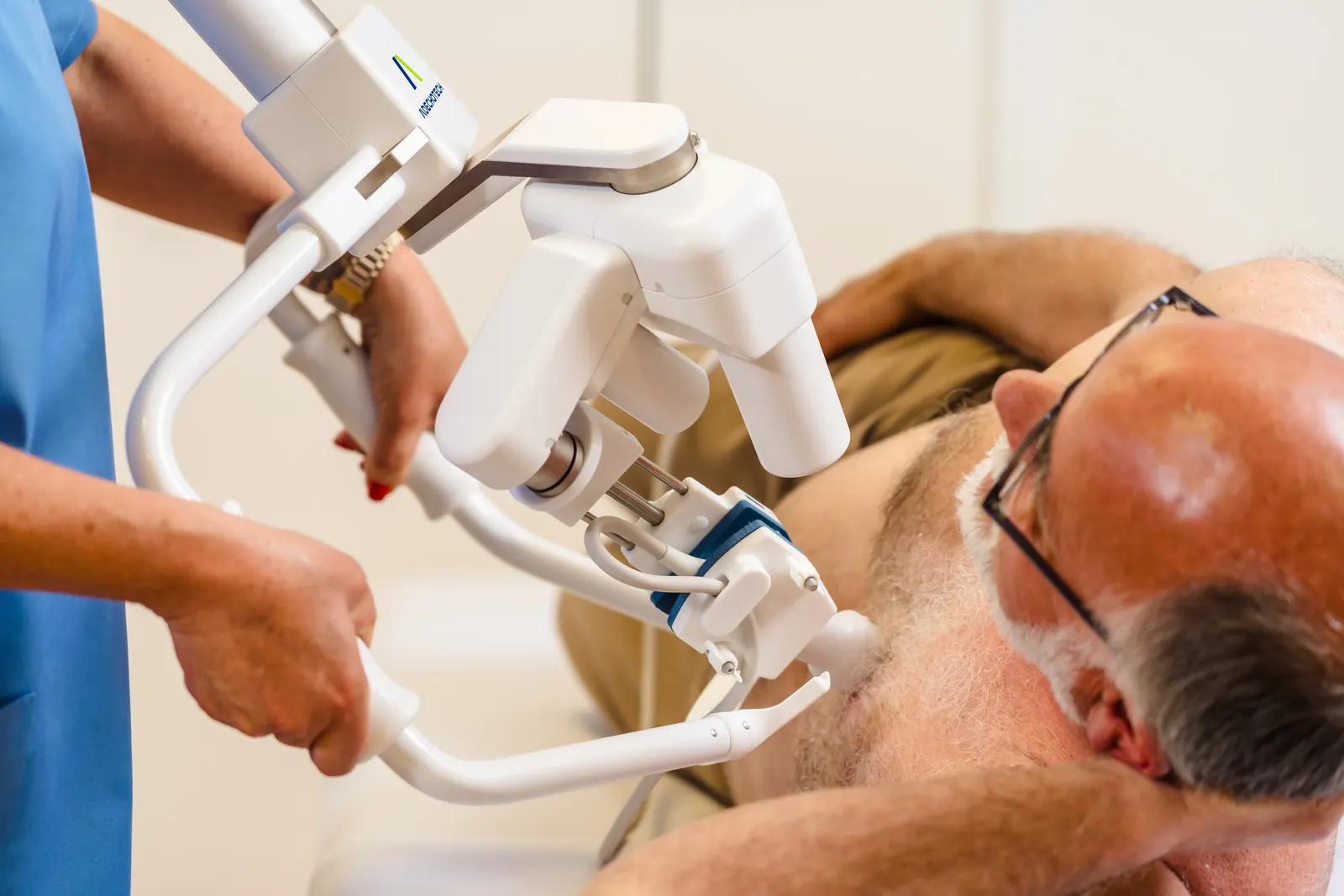 Cardiac examination with MELODY: close-up of the robotic arm and probe on the chest of a patient lying on his side
